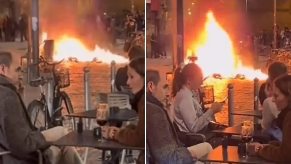 KOGA BRIGA ZA PROTESTE Par uživa u bašti restorana dok u pozadini "gori" Pariz (VIDEO)